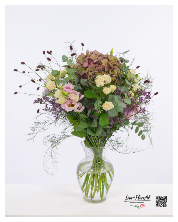 Filigraner Blumenstrauß mit Hortensie, Lisianthus und Rosen, ergänzt durch die feinen Akzente des Strandflieders, der eine natürliche Leichtigkeit und elegante Anmut verströmt.