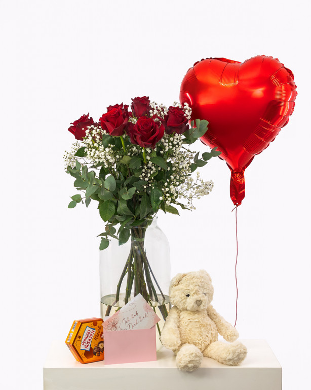 Ein Zeichen der Zuneigung: 10 tiefrote Premium-Rosen, ein kuschelweicher Teddybär, süße Ferrero Küsschen, ein Herzballon und Ihre persönliche Botschaft – alles, um einem besonderen Menschen ein Lächeln zu schenken.